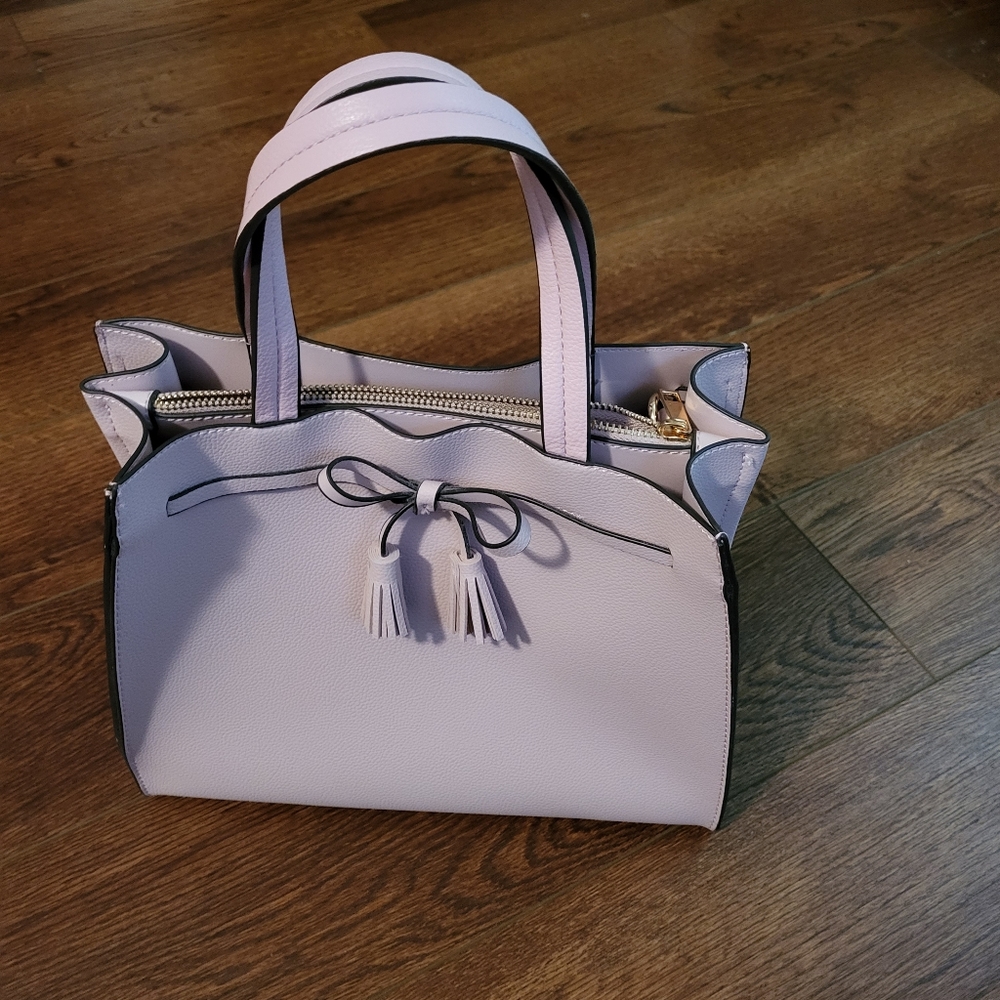 MKF collection is the closest thing I can find.  No label on the purse.